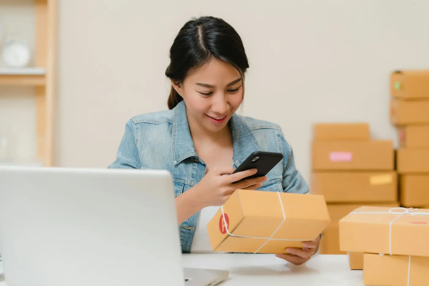 A store owner checking an order on her phone