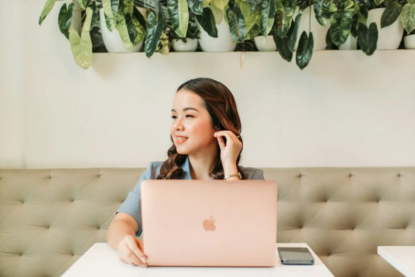 A creator working at her laptop in a café