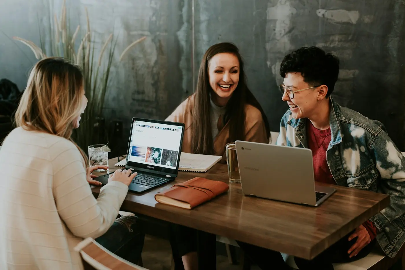 An agency team working together around their laptops